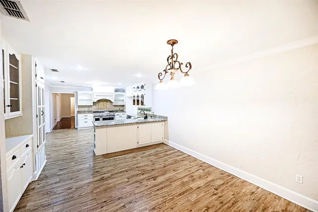 a view of kitchen with kitchen island microwave and stove