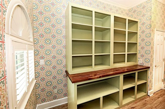 a view of a room with wooden floor and windows