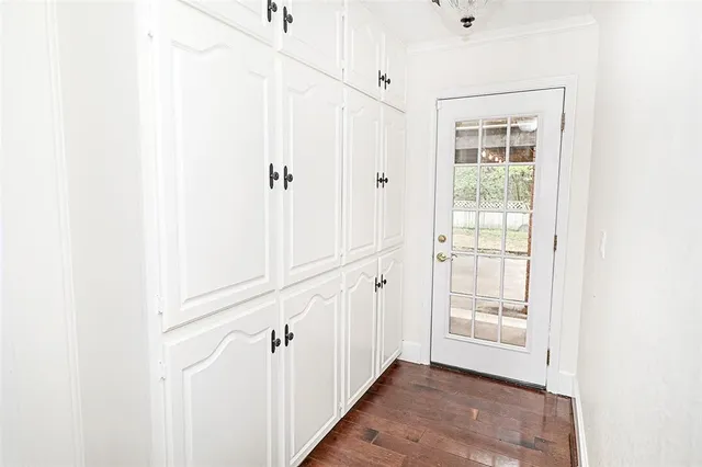 a view of an entryway with wooden floor
