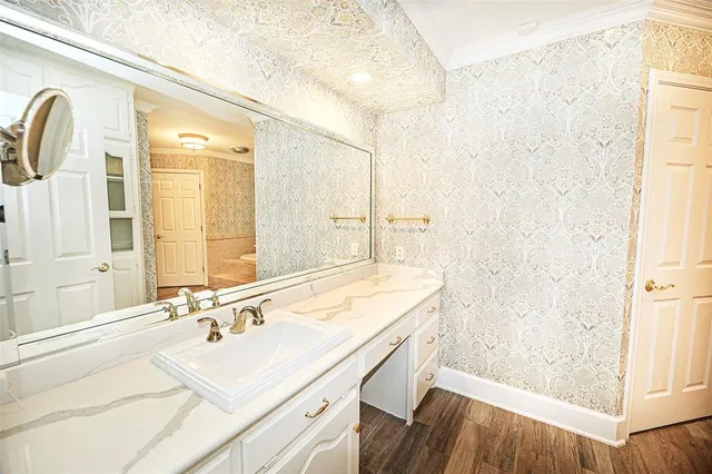 a bathroom with a sink a mirror and a shower