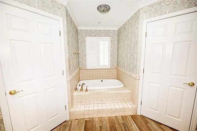 a bathroom with a bathtub and shower