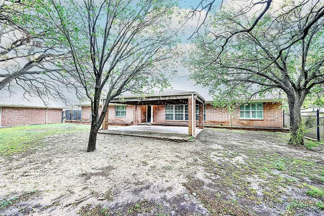 a white house that has a tree in front of it