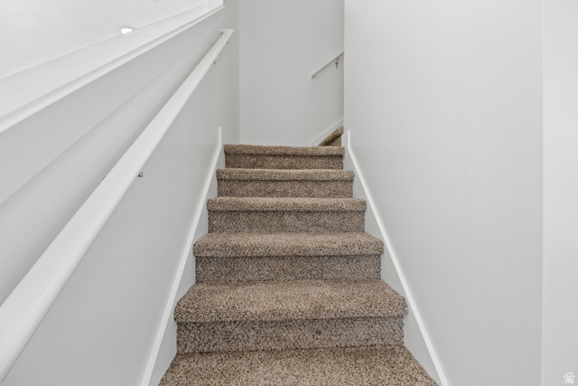 1271 West 500 South Logan, UT 84321 - Photo 11 of 26 Carpeted staircase featuring white wall-mounted handrails