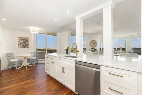 a kitchen with a sink cabinets and wooden floor