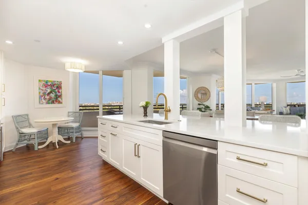 a kitchen with a sink cabinets and wooden floor