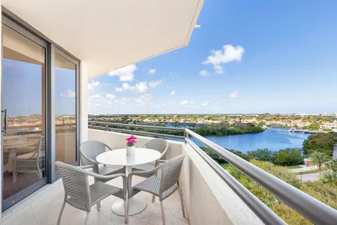 a view of a terrace with furniture and a floor to ceiling window