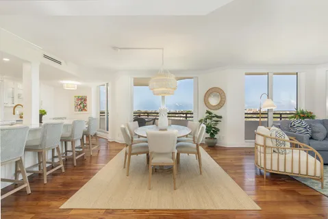 a living room with dining room and wooden floor