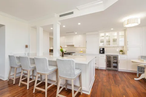 a large kitchen with a table and chairs