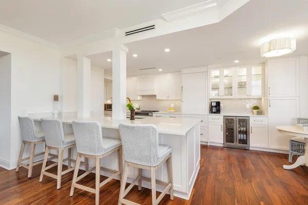a large kitchen with a table and chairs