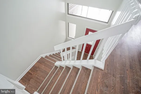 a view of staircase with white walls and a window