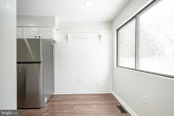 a view of a kitchen with a refrigerator and a window