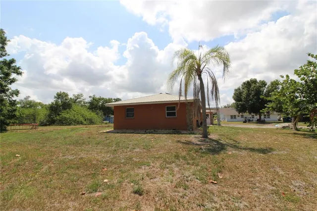 a view of a field with trees in the background