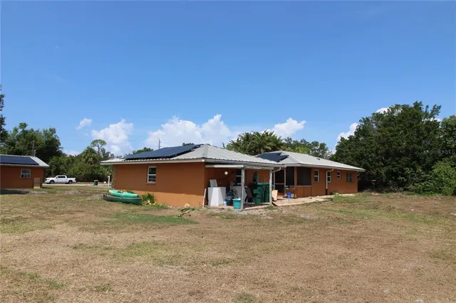 a view of a house with a yard and sitting area