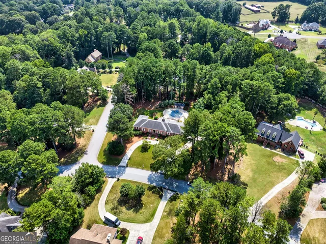 an aerial view of residential house with outdoor space and swimming pool