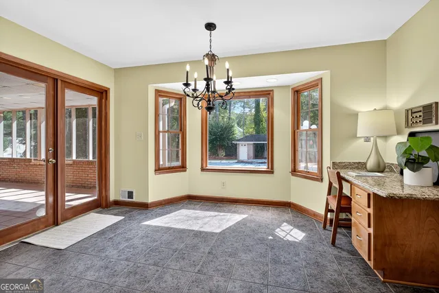 a view of a hallway with wooden floor and entryway