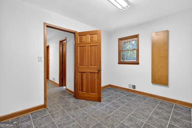 a bathroom with a granite countertop sink and a shower