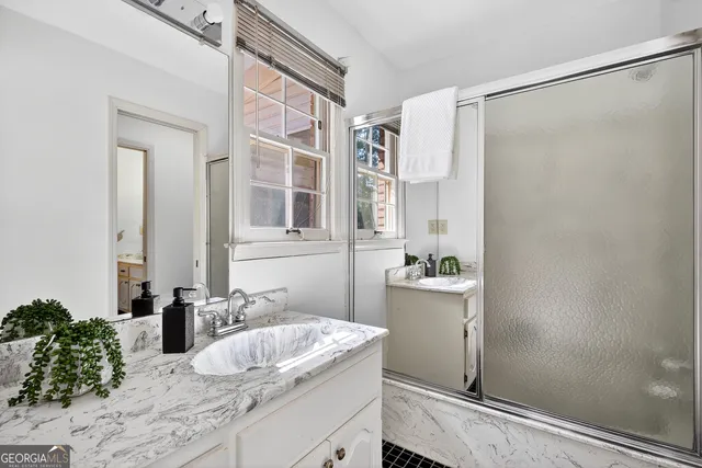 a bathroom with a sink tub and a mirror