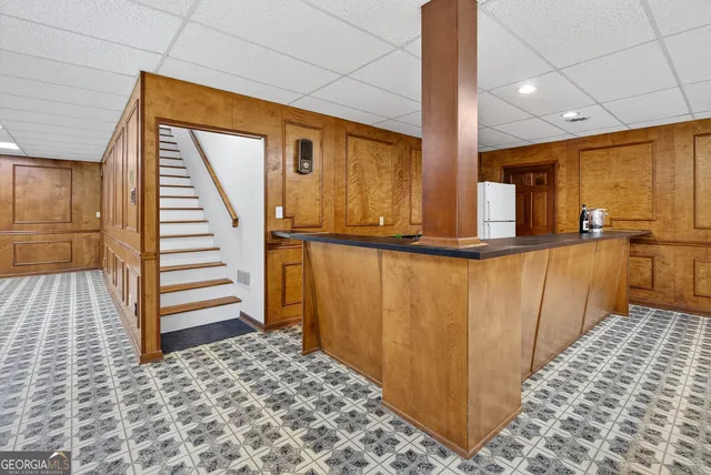 a front view of a house with yard and green space