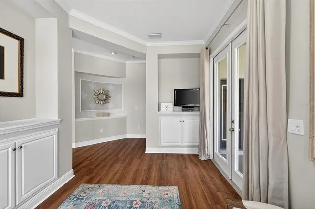 a living room with furniture and floor to ceiling windows