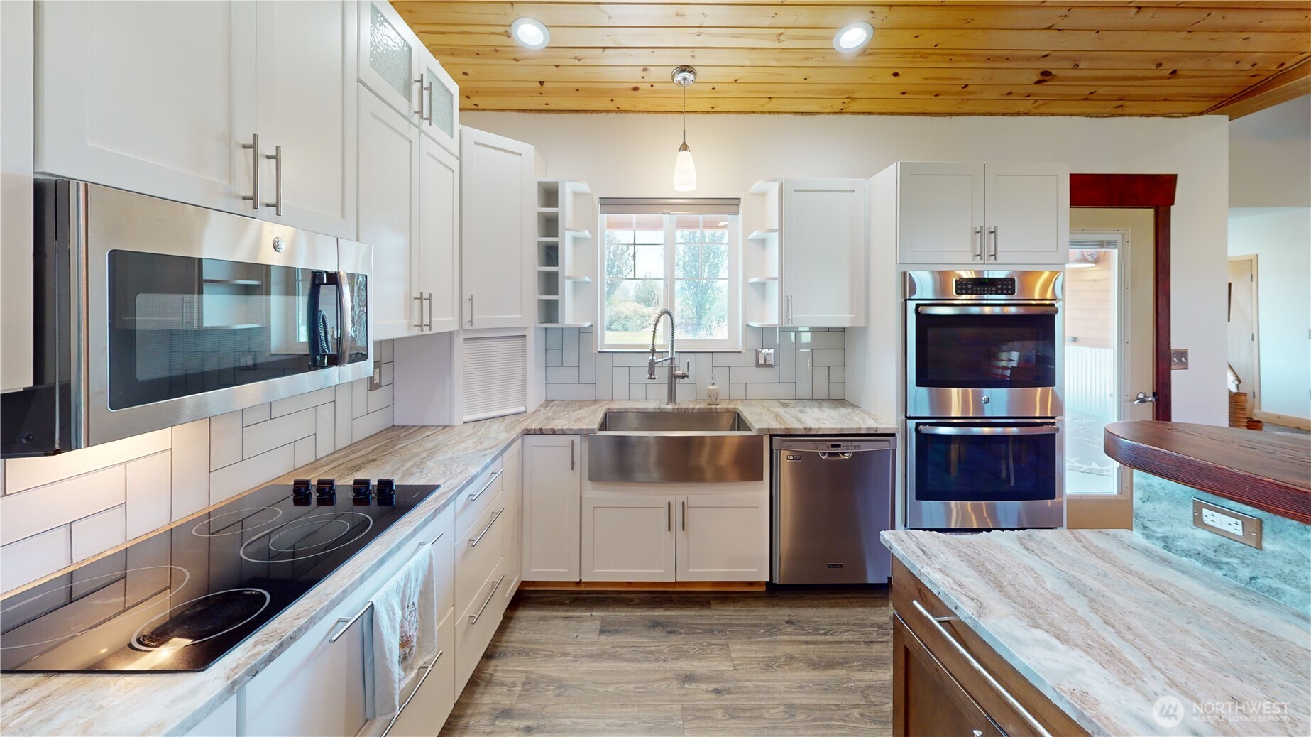 71 Shumway Road Omak, WA 98841 - Photo 11 of 40 a large kitchen with stainless steel appliances wooden cabinets and a stove top oven