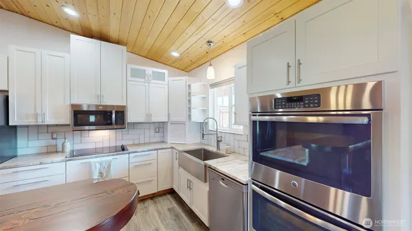 a kitchen with a stove and a white refrigerator