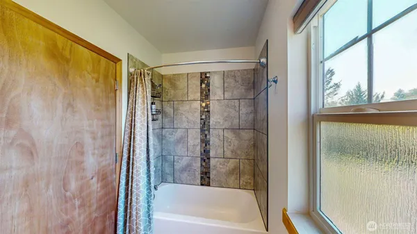 a bathroom with a shower and a bathtub