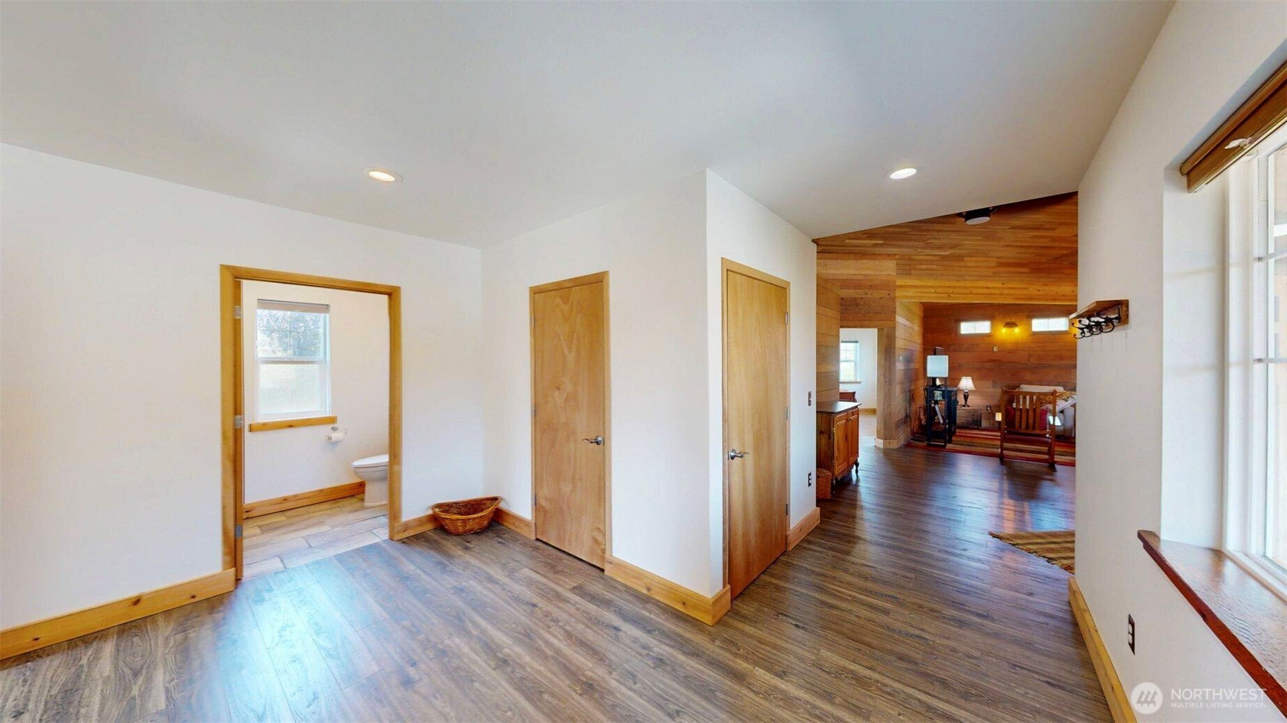 71 Shumway Road Omak, WA 98841 - Photo 25 of 40 a view of a hallway with wooden floor and a living room