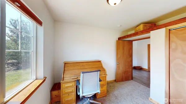 a view of room with window and hallway