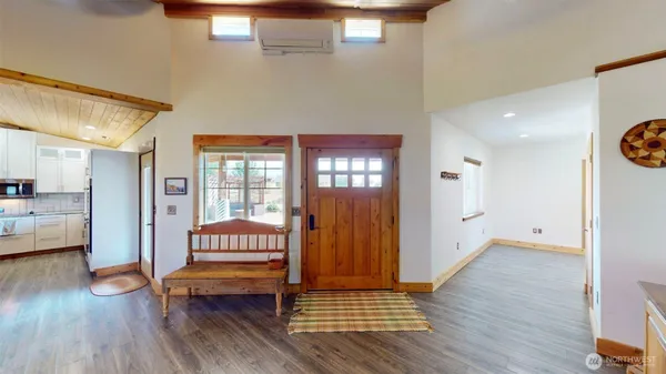 a view of a room with wooden floor and furniture