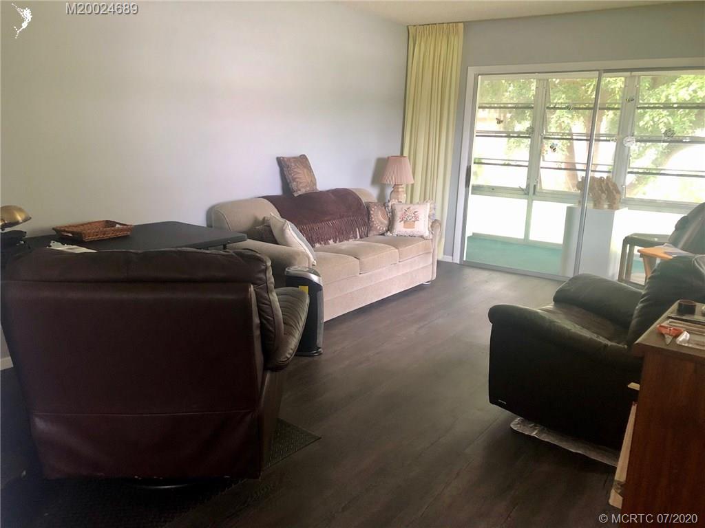 1225 Northwest 21st Street, Unit 2908 Stuart, FL 34994 - Photo 13 of 56 a living room with furniture and a window