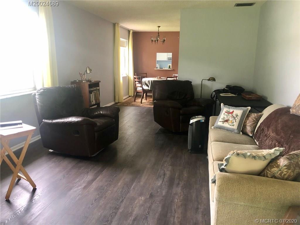 1225 Northwest 21st Street, Unit 2908 Stuart, FL 34994 - Photo 14 of 56 a living room with furniture and a flat screen tv
