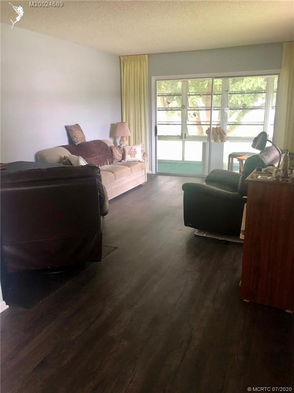 1225 Northwest 21st Street, Unit 2908 Stuart, FL 34994 - Photo 15 of 56 a living room with furniture and a large window