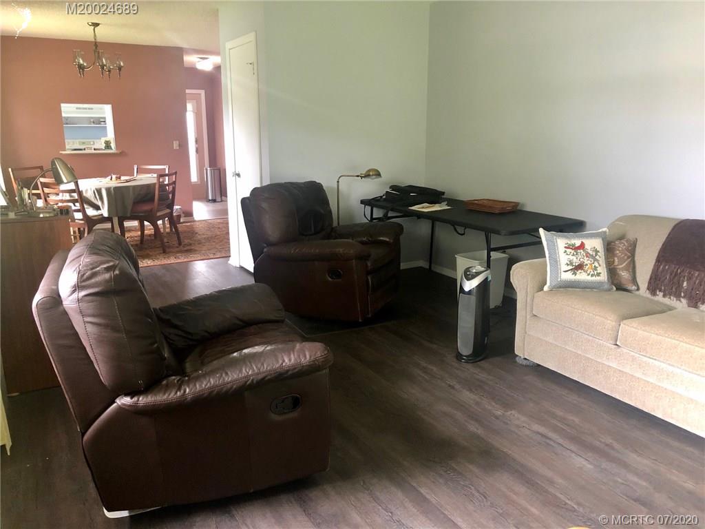 1225 Northwest 21st Street, Unit 2908 Stuart, FL 34994 - Photo 16 of 56 a living room with furniture and a wooden floor