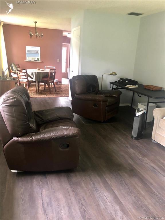 1225 Northwest 21st Street, Unit 2908 Stuart, FL 34994 - Photo 18 of 56 a living room with furniture and a wooden floor