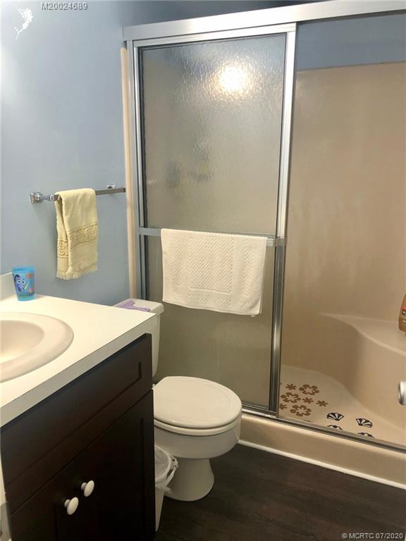 1225 Northwest 21st Street, Unit 2908 Stuart, FL 34994 - Photo 23 of 56 a bathroom with a sink a toilet and shower