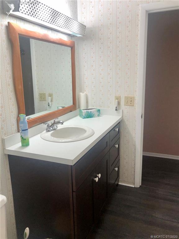 1225 Northwest 21st Street, Unit 2908 Stuart, FL 34994 - Photo 25 of 56 a bathroom with a sink and a mirror