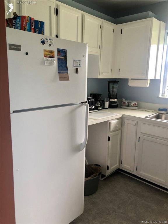 1225 Northwest 21st Street, Unit 2908 Stuart, FL 34994 - Photo 4 of 56 a white refrigerator freezer sitting in a kitchen