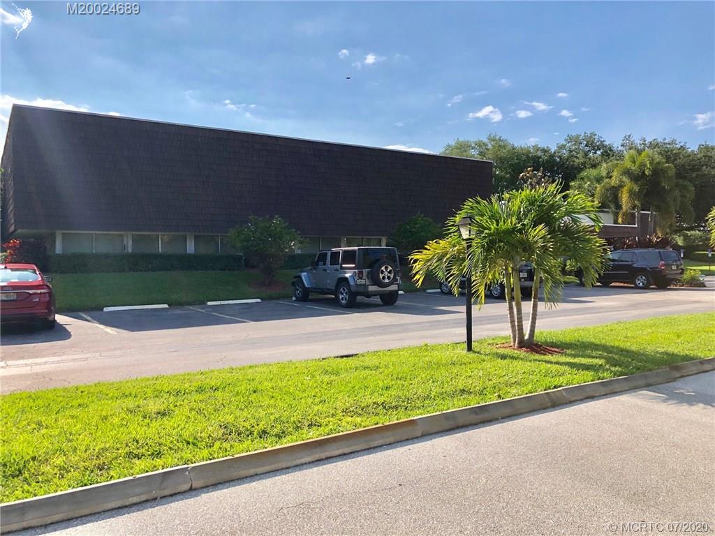 1225 Northwest 21st Street, Unit 2908 Stuart, FL 34994 - Photo 42 of 56 a swimming pool with a lots of trees in the background