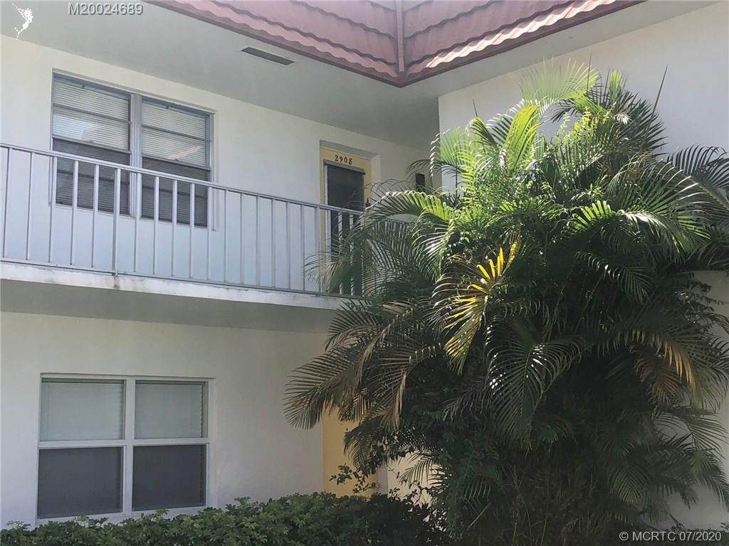 1225 Northwest 21st Street, Unit 2908 Stuart, FL 34994 - Photo 54 of 56 a view of a house with a yard
