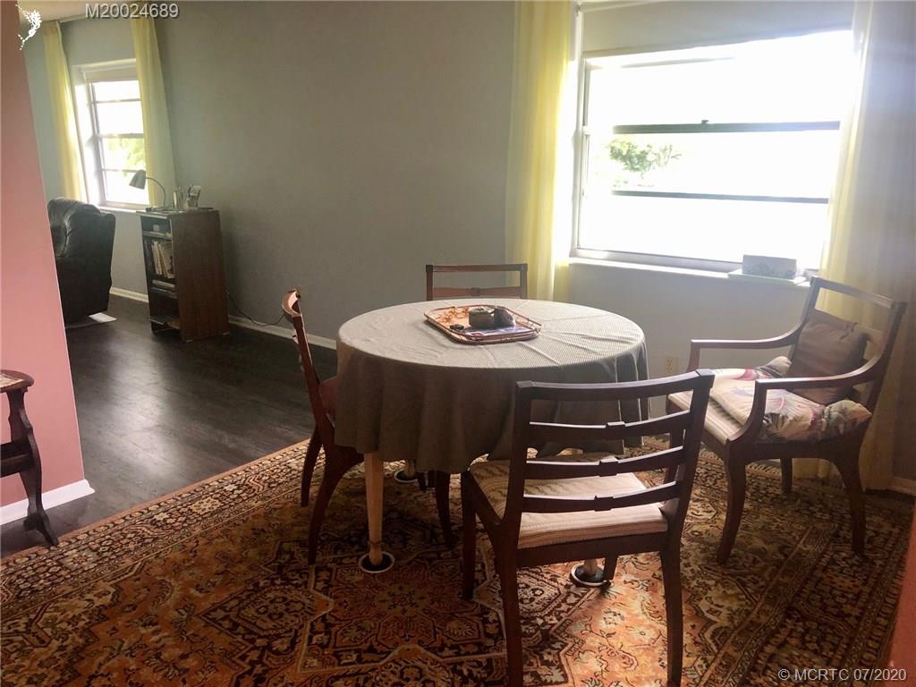 1225 Northwest 21st Street, Unit 2908 Stuart, FL 34994 - Photo 7 of 56 a view of a dining room with furniture and wooden floor