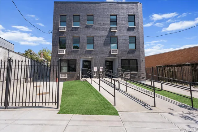 a view of a brick house with a yard