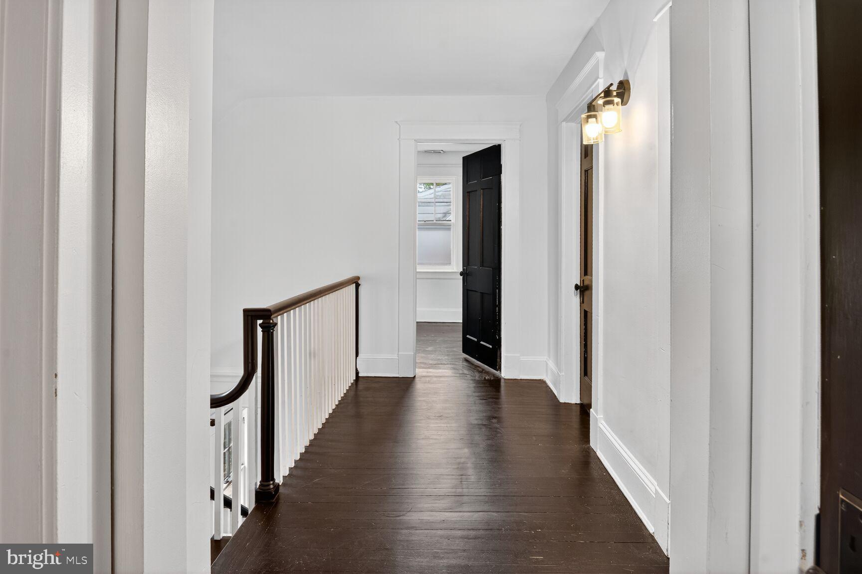 719 Brinkwood Road Baltimore, MD 21229 - Photo 15 of 31 a view of a hallway with wooden floor and staircase