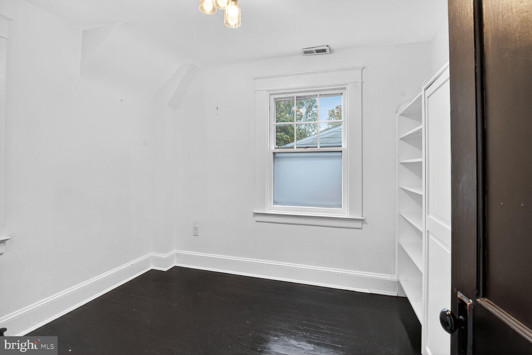 719 Brinkwood Road Baltimore, MD 21229 - Photo 17 of 31 an empty room with wooden floor and windows