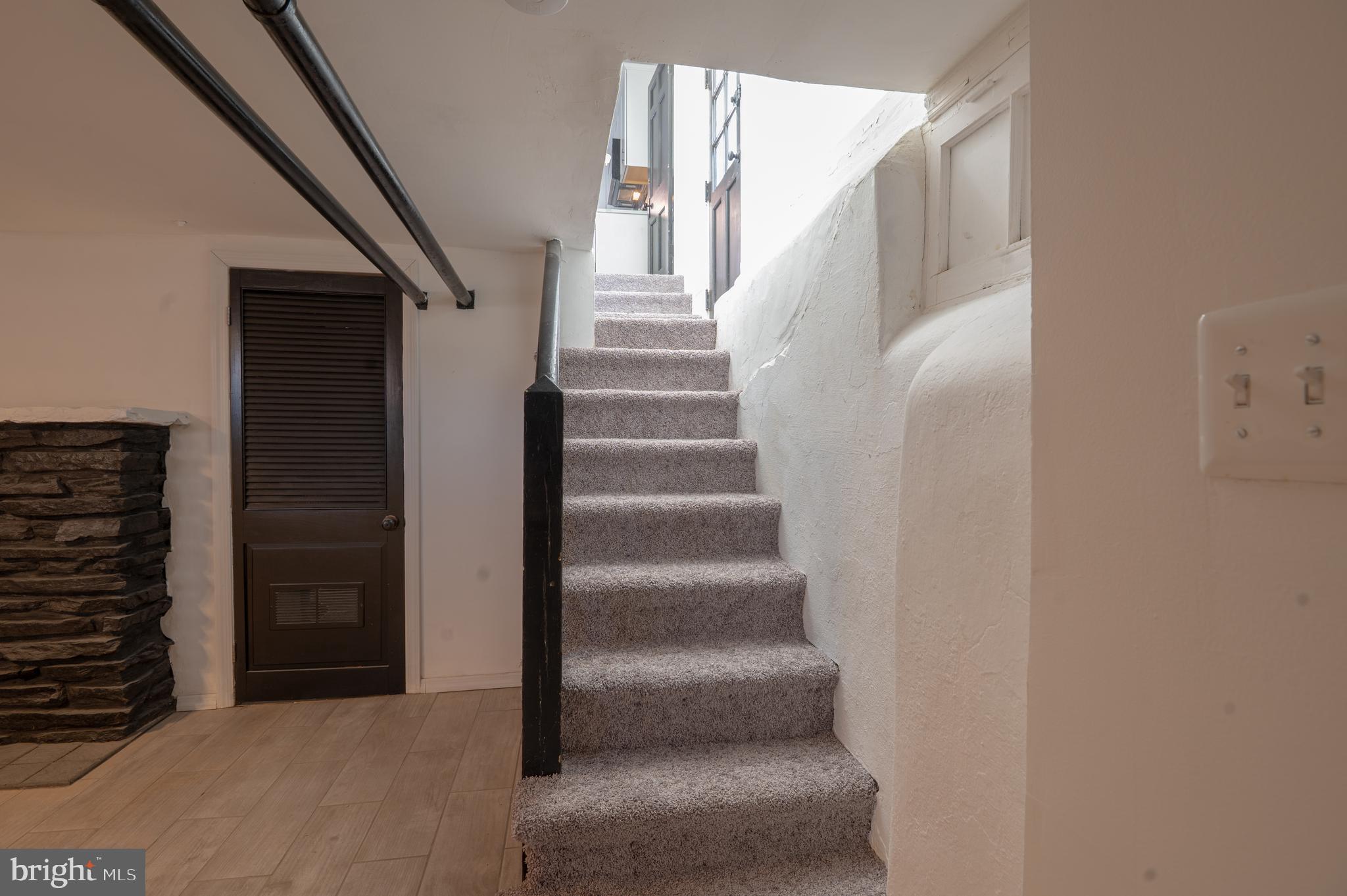 719 Brinkwood Road Baltimore, MD 21229 - Photo 23 of 31 a view of staircase with white walls and windows