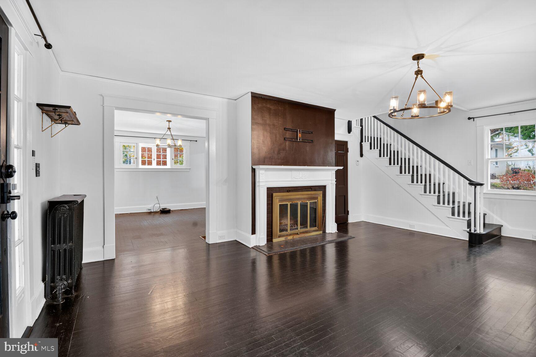 719 Brinkwood Road Baltimore, MD 21229 - Photo 5 of 31 a view of a livingroom with wooden floor and a fireplace