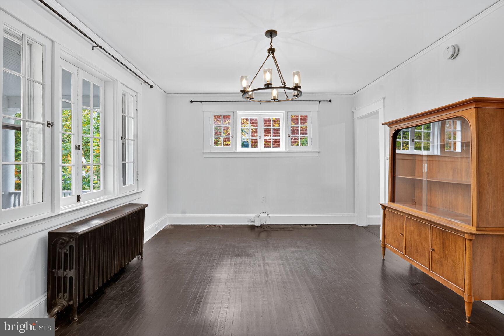719 Brinkwood Road Baltimore, MD 21229 - Photo 7 of 31 a view of an empty room with wooden floor and a window
