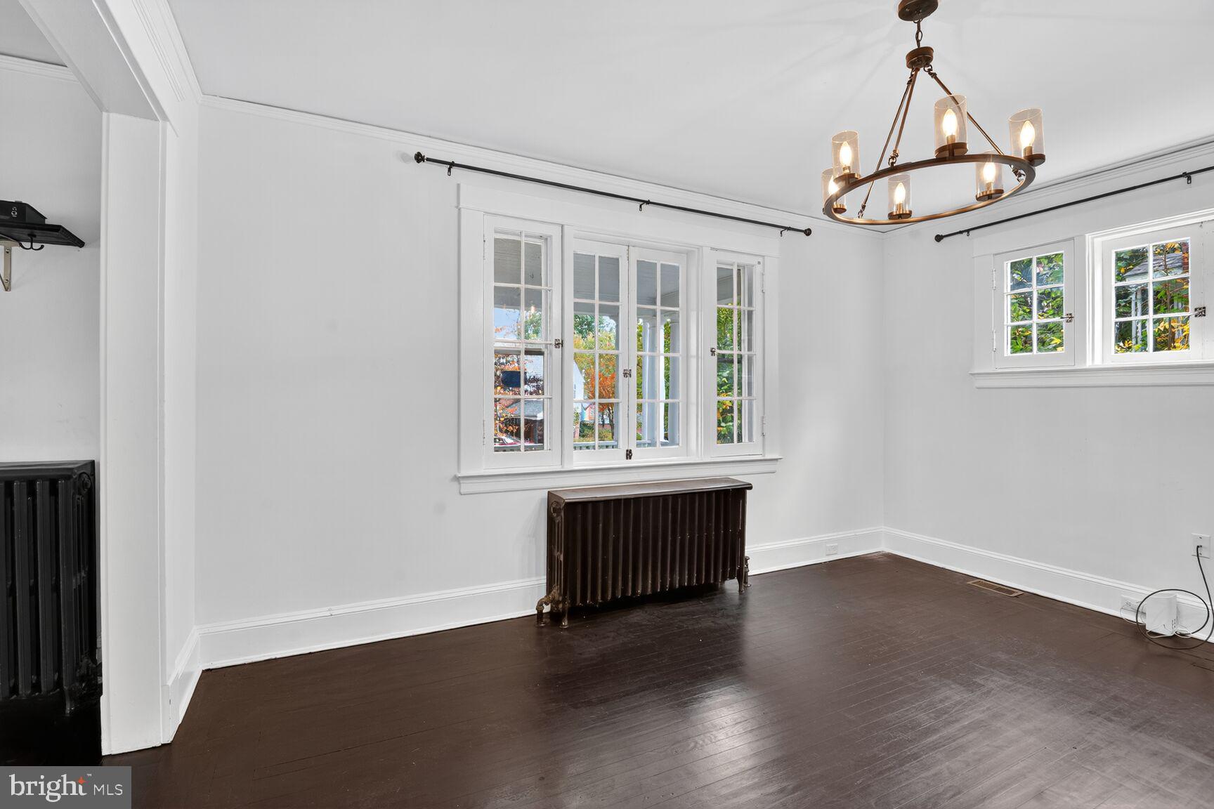 719 Brinkwood Road Baltimore, MD 21229 - Photo 8 of 31 an empty room with wooden floor cabinet and windows
