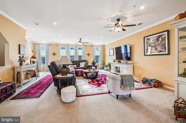 a living room with furniture and kitchen view