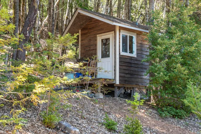 a view of a house with a yard and sitting area