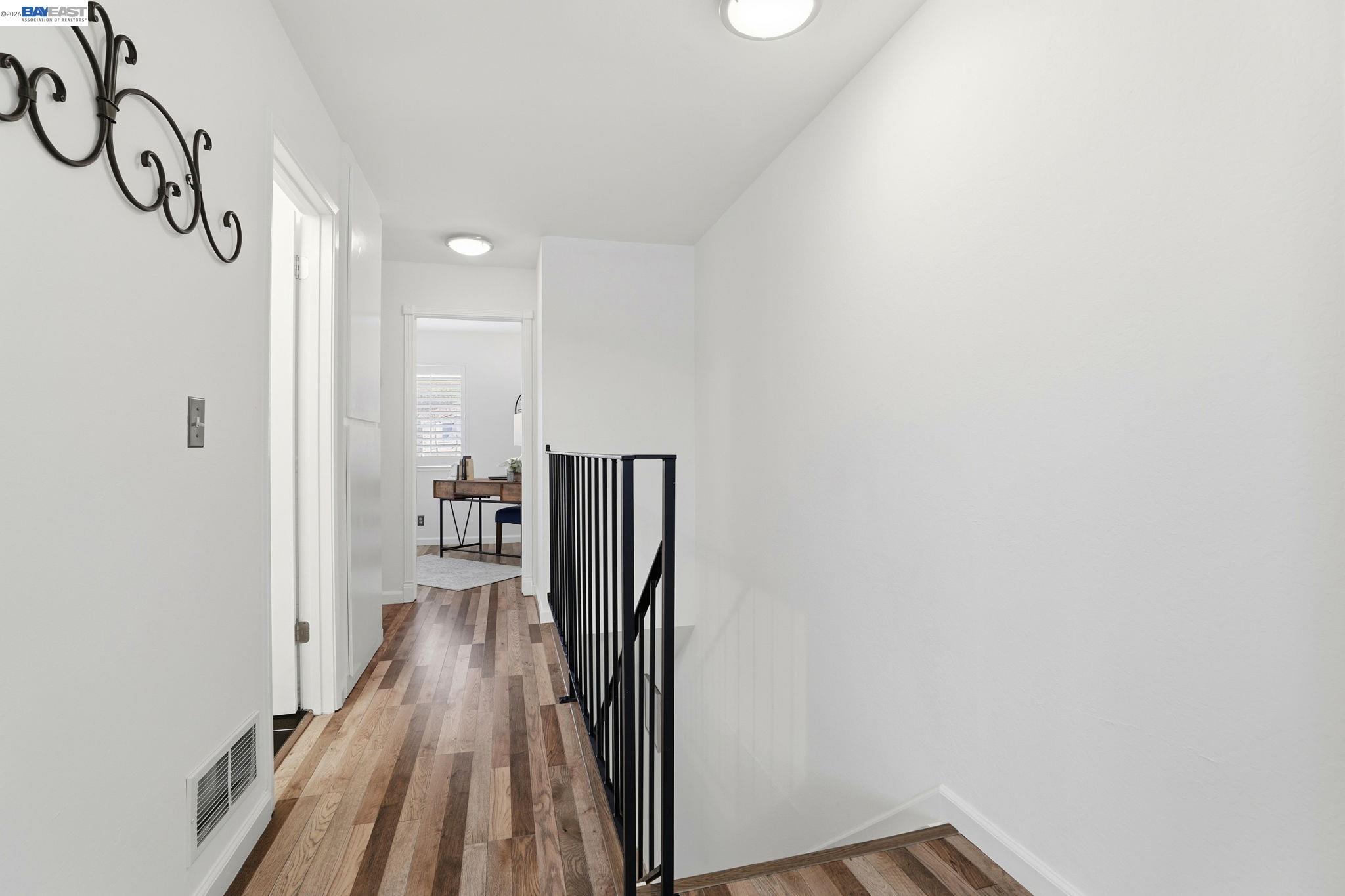 38524 Burdette Common Fremont, CA 94536 - Photo 18 of 35 a view of a hallway with wooden floor and staircase